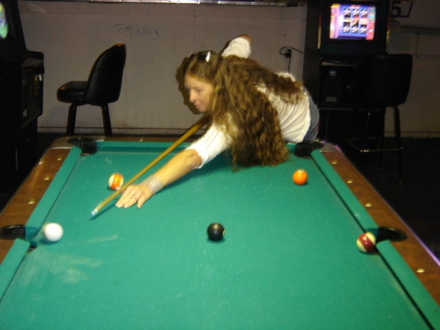 Gina shooting pool at Grant's Lounge